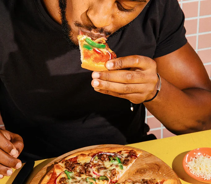 Man eating vegan pizza
